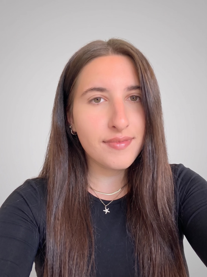Lana, founder of Petit Studio, smiling in a black top